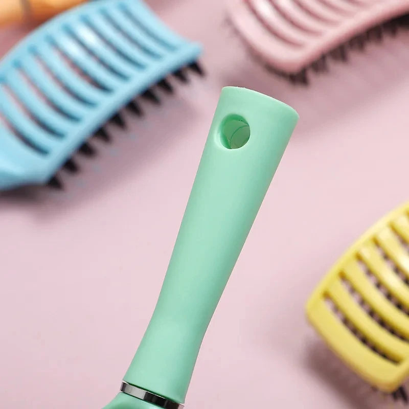 Image displaying the handle of a green Detangle Bliss Brush